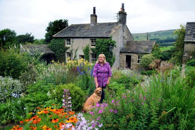 Susan and her dog, Tessa, in the garden that she designed and planted