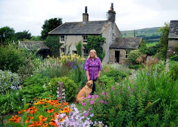 Susan and her dog, Tessa, in the garden that she designed and planted