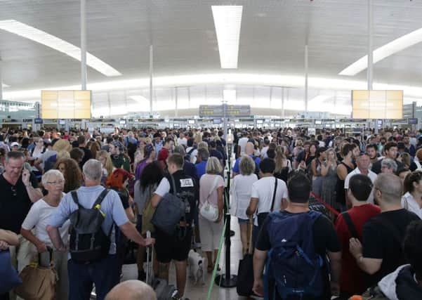 Passengers wait for pass security control at the Barcelona airport in Prat Llobrega.