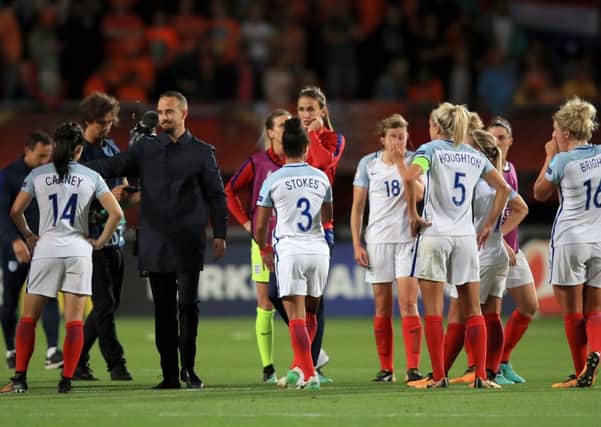 Out: England players appear dejected after the final whistle.