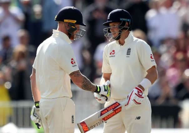 Well done captain: Joe Root, right, is congratulated by team-mate Ben Stokes after recording a half-century for England for the 10th match in succession. (Picture: PA)