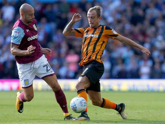 Hull City's Kamil Grosicki takes on Alan Hutton