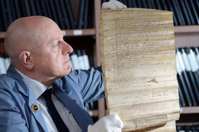Borough archivist Dr Charles Kelham with a 700 year old document which makes up part of the Conisbrough Manorial Court Rolls.