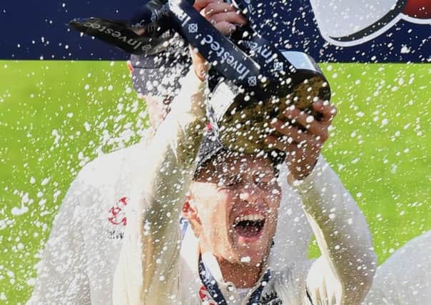 Yorkshires Joe Root is sprayed with bubbly as he holds aloft the Investec Series trophy after England  in their first series under his captaincy  beat South Africa at Old Trafford to complete a 3-1 triumph (Picture: Anthony Devlin/PA Wire).