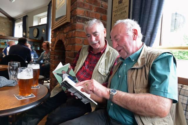 Locals Mick Harrison and John Driver,  reading poetry books at the Riverhead Tap,  one of the poerty pubs in Marsden.
 Picture: Bruce Rollinson