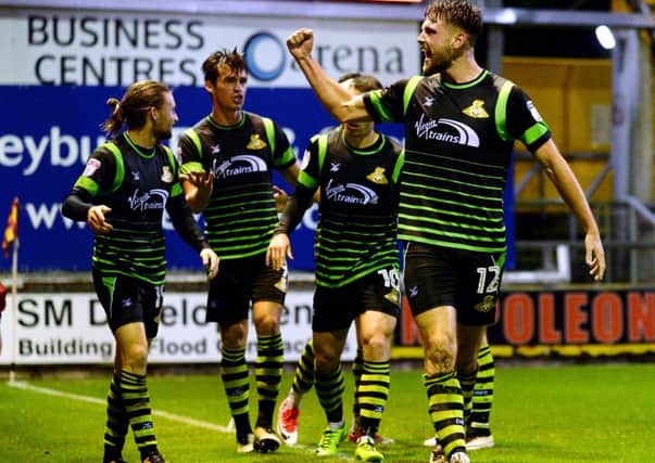 Ben Whitehead and Doncaster Rovers team-mates celebrate the visitors' late winning goal at 
Bradford City (Picture: Bruce Rollinson).