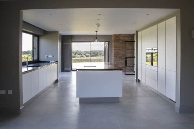 The contemporary kitchen and large areas of glazing