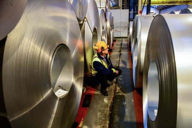 File photo dated 15/02/17 of a worker inspecting rolls of steel. Output in Britain's manufacturing industry eased back from a three-year high, but beat expectations in May thanks to robust growth in new orders. PRESS ASSOCIATION Photo. Issue date: Thursday June 1, 2017. The closely watched Markit/CIPS UK Manufacturing purchasing managers' index (PMI) showed a reading of 56.7 last month, down from 57.3 in April and above economists' expectations of 56.5. See PA story ECONOMY Manufacturing. Photo credit should read: Ben Birchall/PA Wire