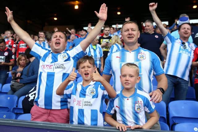 Huddersfield Town fans show their support in the stands.