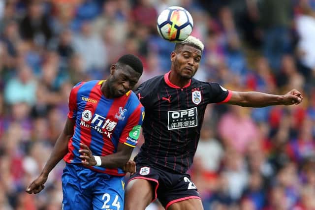 Crystal Palace's Timothy Fosu-Mensah (left) and Huddersfield Town's Steve Mounie battle for the ball.
