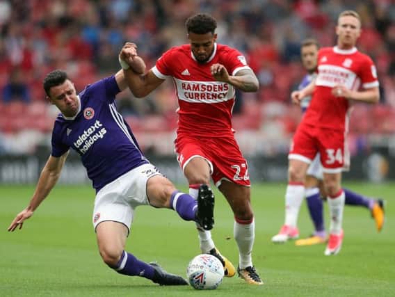 Sheffield United's Enda Stevens (left) and Middlesbrough's Cyrus Christie battle for the ball (Photo: PA)