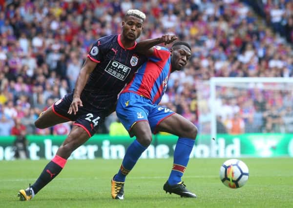 Hero: Huddersfield Town's Steve Mounie and Crystal Palace's Timothy Fosu-Mensah battle for the ball.