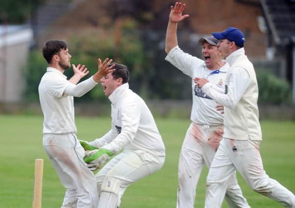 Match winner: Alex Lilley, left, after taking his fifth wicket and Bilton's final wicket to win the game fore league leaders Beckwithshaw.
Picture: Steve Riding
