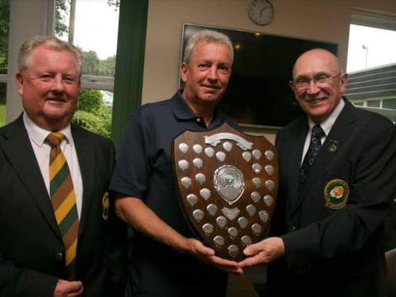 Halifax Bradley Hall's Andy Whitworth  receives the Halifax-Huddersfield Union's seniors championship trophy from competition sponsor Phil Tatlock (Outlane). The trophy is in memory of his wife Liz. On the left is union president John Turner (Crow Nest Park).