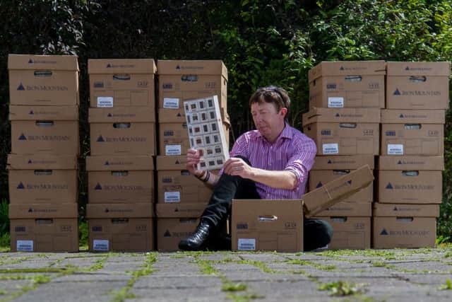 Tony Jameson-Allen sat with the boxes looking at one of the thousand of files sheets containing sporting images taken around the world.

Pictures: James Hardisty