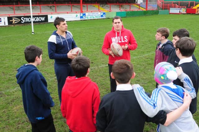 Keighley Cougars player Brendon Rawlins, right, works with young teenagers at Your Sporting Chance, a project based at the club which aimed to steer the students away from crime and back into education. (Picture: Tony Johnson)