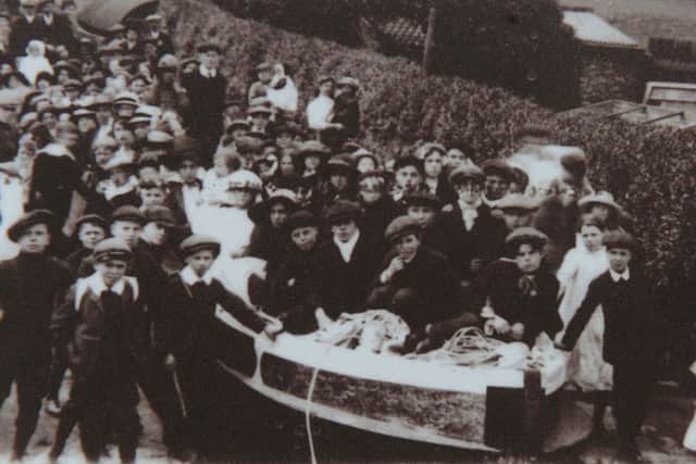 Historical photo of members of the Staveley community with a Cuckoo boat