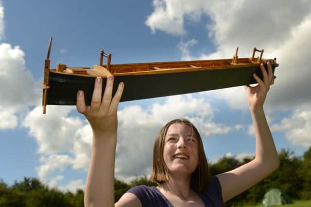 Volunteer Charlotte Robinson with a model of a Cuckoo boat. Picture Scott Merrylees
