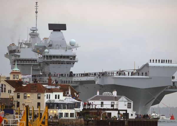 HMS Queen Elizabeth, the UK's newest aircraft carrier, arrives in Portsmouth for the first time.