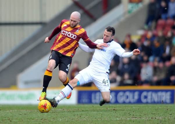 Old pals: 
Bantams' Nicky Law being tackled by Bolton Wanderers' Adam Le Fondre, his former Rotherham team-mate.