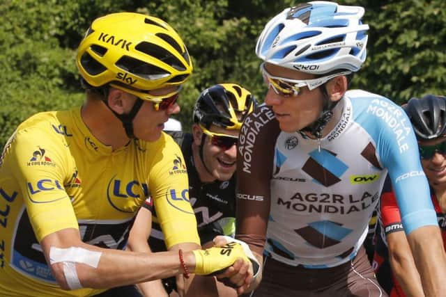 Britain's Chris Froome, wearing the overall leader's yellow jersey, is congratulated by France's Romain Bardet during the twenty-first stage of the Tour de France. (AP Photo/Christophe Ena)