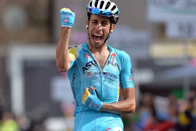 Italy's Fabio Aru celebrates as he crosses the finish line to win the 15th stage of the Giro D'Italia in 2014. (AP Photo/Gian Mattia D'Alberto)