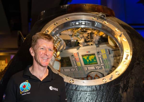 British astronaut Tim Peake with the Russian Soyuz capsule which carried him and his crew to and from the International Space Station. Picture by Dominic Lipinski/PA Wire.
