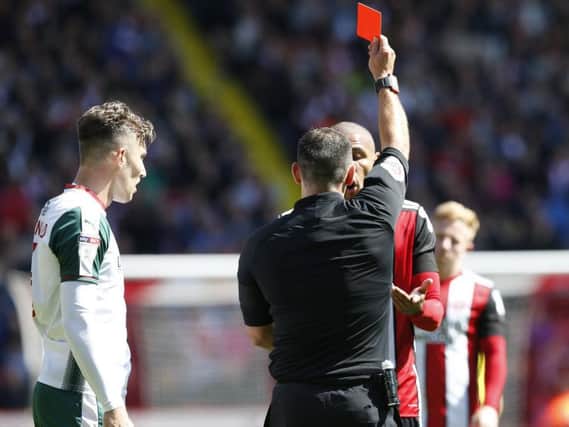 Referee Tim Robinson shows a red card to Leon Clarke (Photo: Sportimage)