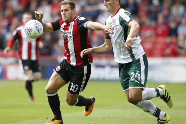 Billy Sharp tussles with Barnsley defender Matty Pearson (Photo: Sportimage)
