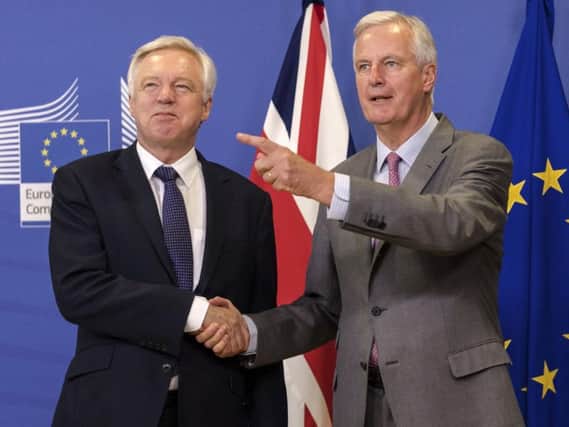 EU chief Brexit negotiator Michel Barnier, right, welcomes British Secretary of State David Davis for a meeting at the EU headquarters in Brussels, Monday July 17, 2017.