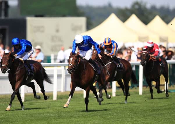 Barney Roy ridden by jockey James Doyle (centre) comes home to win the St James's Palace Stakes. Picture: John Walton/PA