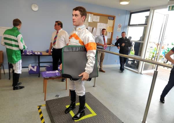 Flat jockey Jason Hart weighs out at Beverley races.