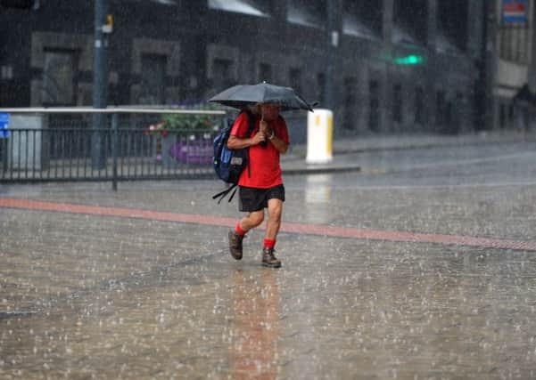 A man braves the rain in Leeds city centre
. PIC: Jonathan Gawthorpe