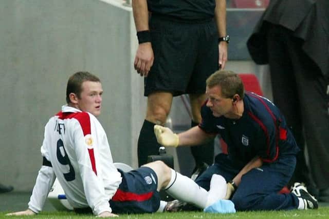 Wayne Rooney (left) receives treatment after an injury against Portugal during the Euro 2004 quarter-final. Picture: Owen Humphreys/PA.