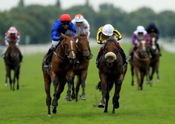 Wells Farhh Go ridden by David Allan (left) before winning the Tattersalls Acomb Stakes ahead of James Garfield ridden by Frankie Dettori. Picture: Tim Goode/PA Wire