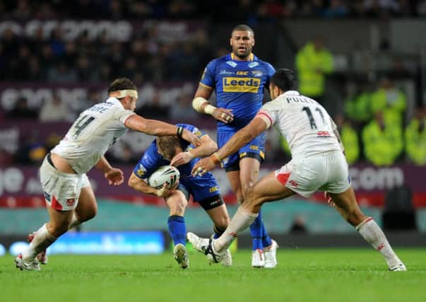 Rob Burrow ducks between St Helens defenders on the way to one of the greatest-ever Grand Final tries in 2011. PIC: Steve Riding