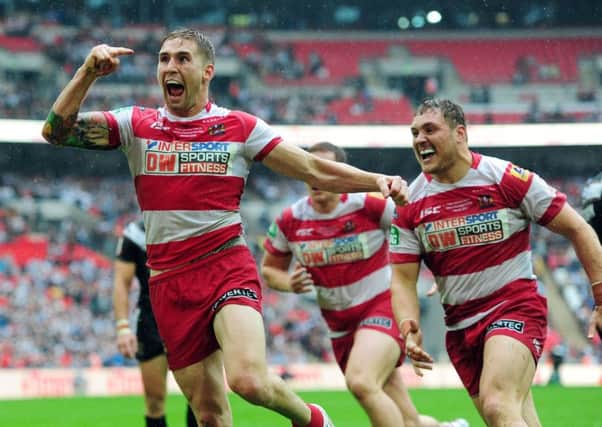 Wigan 's Sam Tomkins (left) celebrates after scoring a try  at Wembley against Hull FC in the 2013 Challenge Cup Final. Picture: PA.