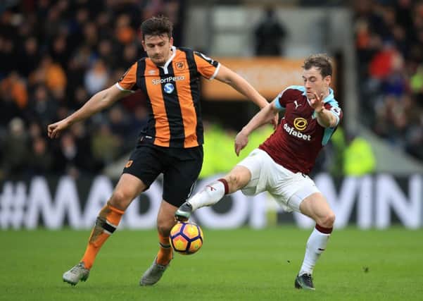 MOVING ON UP: Harry Maguire, left, in acgtion for Hull City against Burnley's Ashley Barnes last season. Picture: Mike Egerton/PA
