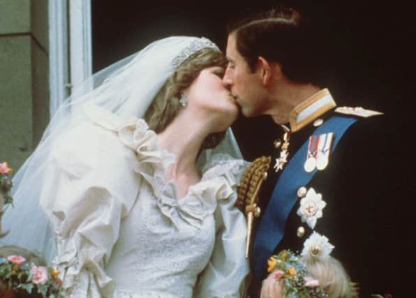 Prince Charles kisses his bride, the former Diana Spencer, on the balcony of Buckingham Palace in London after their wedding. (AP Photo, File)