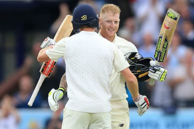 England's Ben Stokes (facing) is congratulated by Chris Woakes after reaching his century at Headingley. Picture: Nigel French/PA