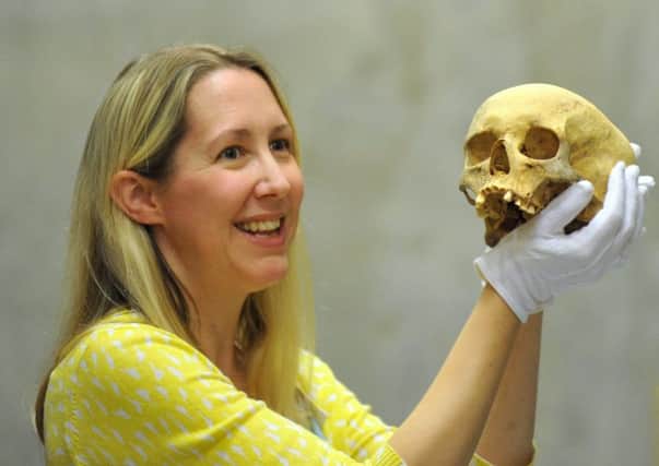 Leeds Museums and Galleries curator of archaeology Kat Baxter with a skull from  the Iron Age woman found at the dig near Bramham.
