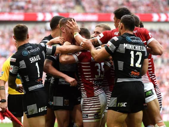 Hull FC and Wigan players face off