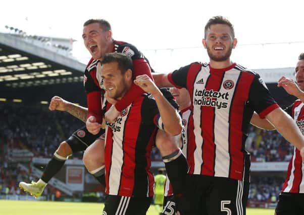 Billy Sharp of Sheffield Utd celebrates with the help of John Fleck and Jack O'Connell (Picture: Simon Bellis/Sportimage)