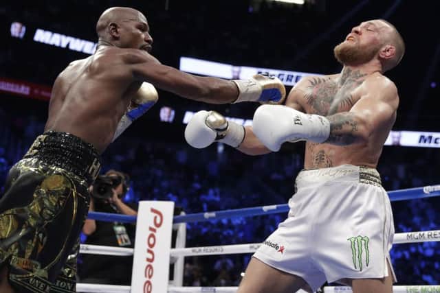 Crunch: Floyd Mayweather Jr catches Conor McGregor in their super welterweight fight.
Picture: AP Photo/Isaac Brekken
