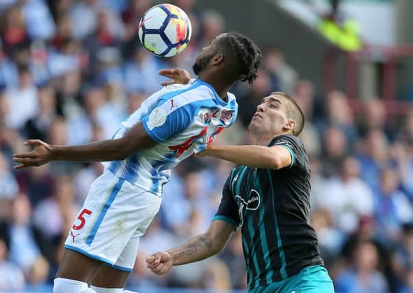 In control: Huddersfield Town's Kasey Palmer shields the ball from Southampton's Oriol Romeu.