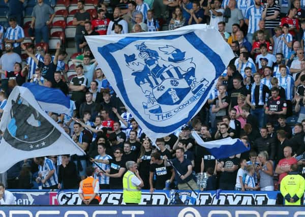 Flying the flag: Huddersfield Town fans show their support.