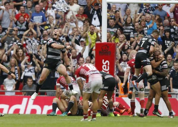 Hull FC's Gareth Ellis celebrates at the end as Wigan's players lay devastated. (PIcture: PA)