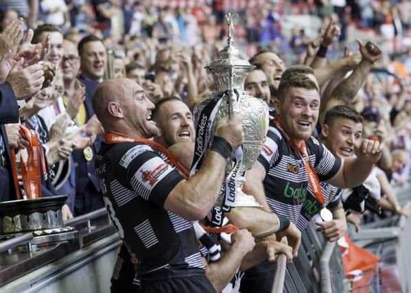 Gareth Ellis gets ready to hold the Challenge Cup trophy aloft (Picture: SWPix.com)
