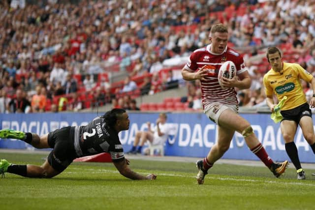 Wigan Warriors' Joe Burgess scores his side's third try during the Ladbrokes Challenge Cup Final at Wembley Stadium, London.