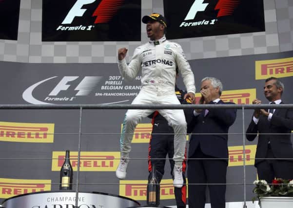 Fighting back: Lewis Hamilton punches the air after securing victory in the Belgian Grand Prix at Spa yesterday. (Picture: AP)